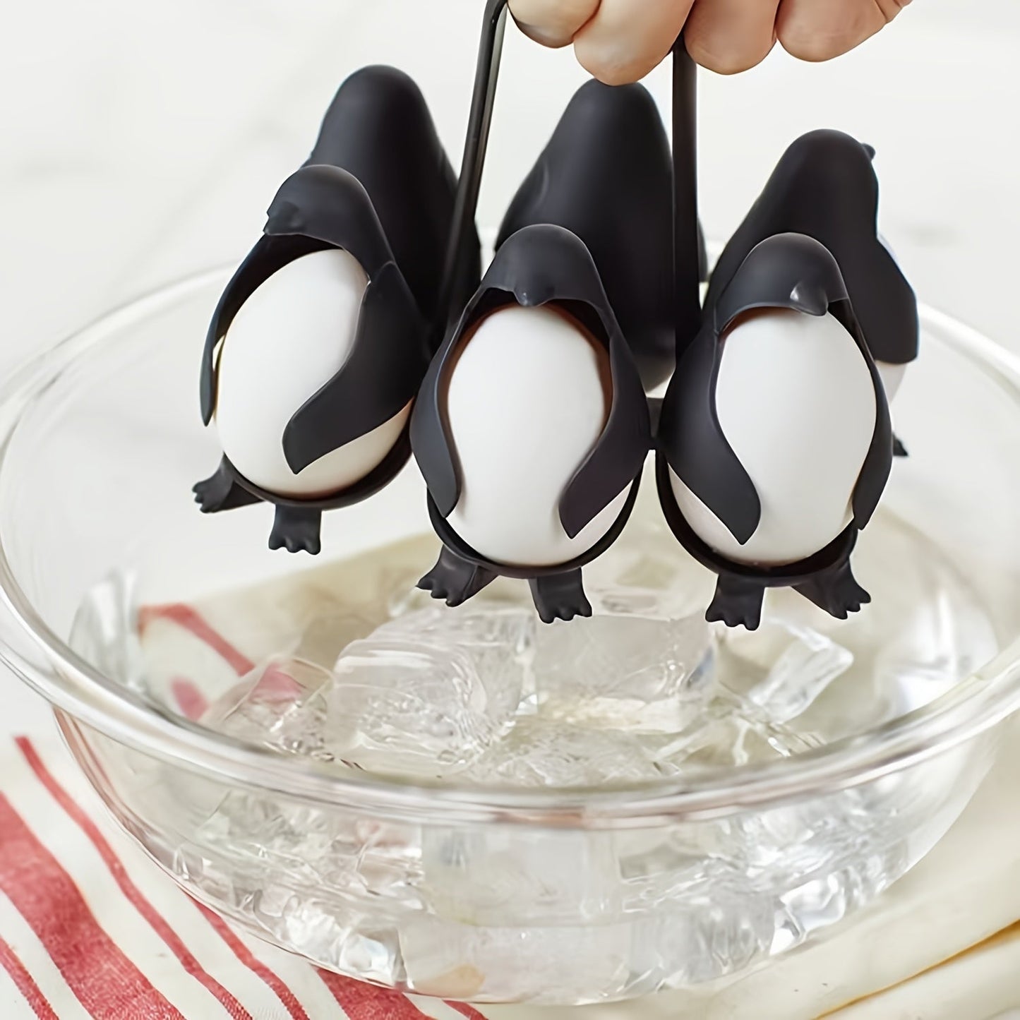 A set of 6 Penguin Egg Cookers made of plastic, perfect for boiling both hard and soft eggs. This food-safe kitchen gadget is a great gift idea for Christmas, Thanksgiving, Mother's Day, and Labor Day.