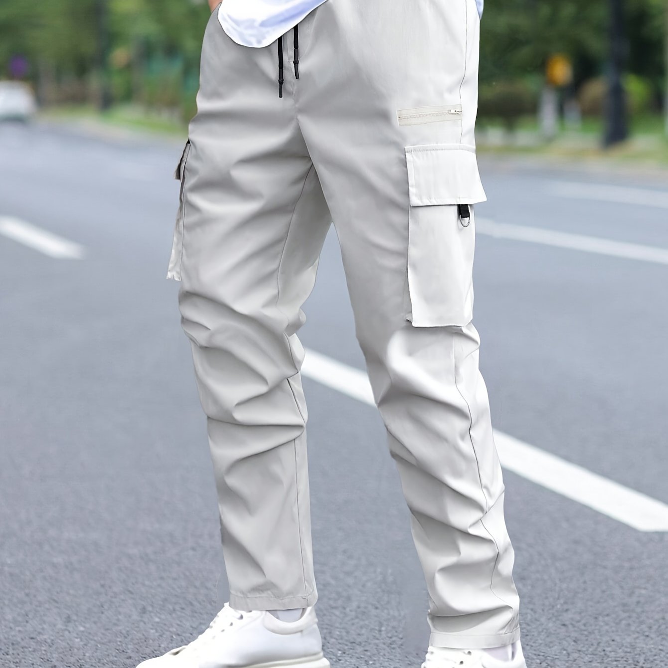 Men's cargo pants with multiple pockets and drawstring for outdoor activities.