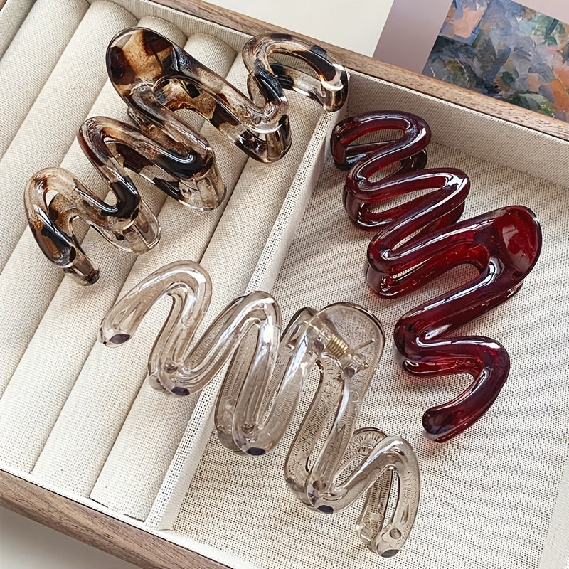 3 Wavy Leopard Print Hair Claw Clips in Clear, Red, and Brown. Stylish plastic accessories for everyday and gifting.