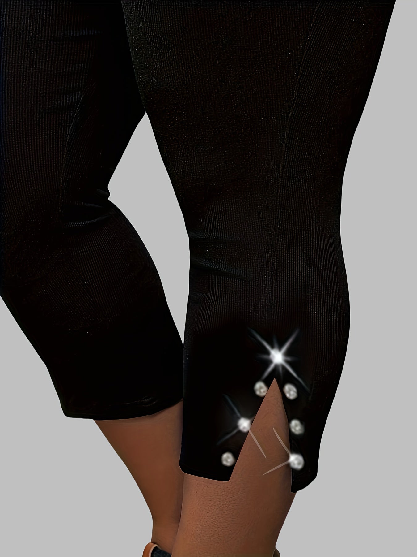 Polyester capri pants with rhinestone detail, slit hem, and high waist for outdoor activities.