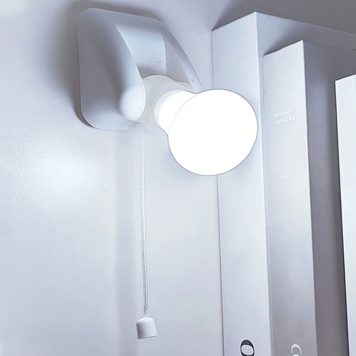 Small white LED night light; battery-powered with cordless design for bedside or cabinet; easy wall mount installation.