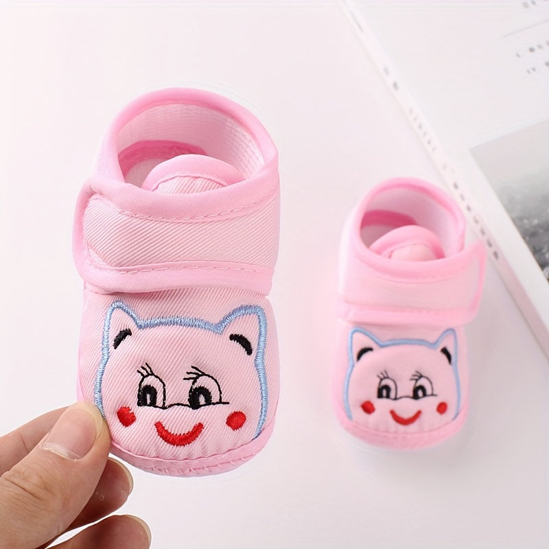 Cute baby walking shoes for boys and girls in light blue with cartoon faces, non-slip soles, and hook-and-loop closure. Ideal for first steps in any season.