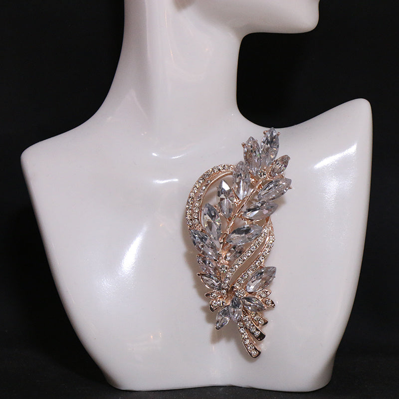 Add a touch of sophistication with our Rhinestone Leaf Brooch Pin - Exquisite design for your dresses and sweaters