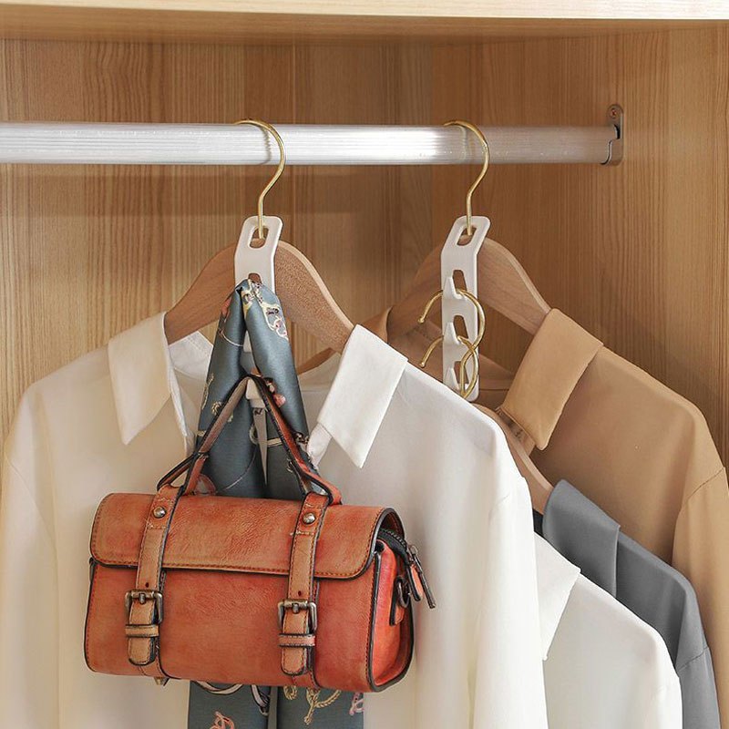 4-piece heavy-duty plastic hanger set with 3 hooks for efficient storage of clothes. Easy to install and a modern wardrobe essential. Great for shirts, jeans, scarves, and coats.