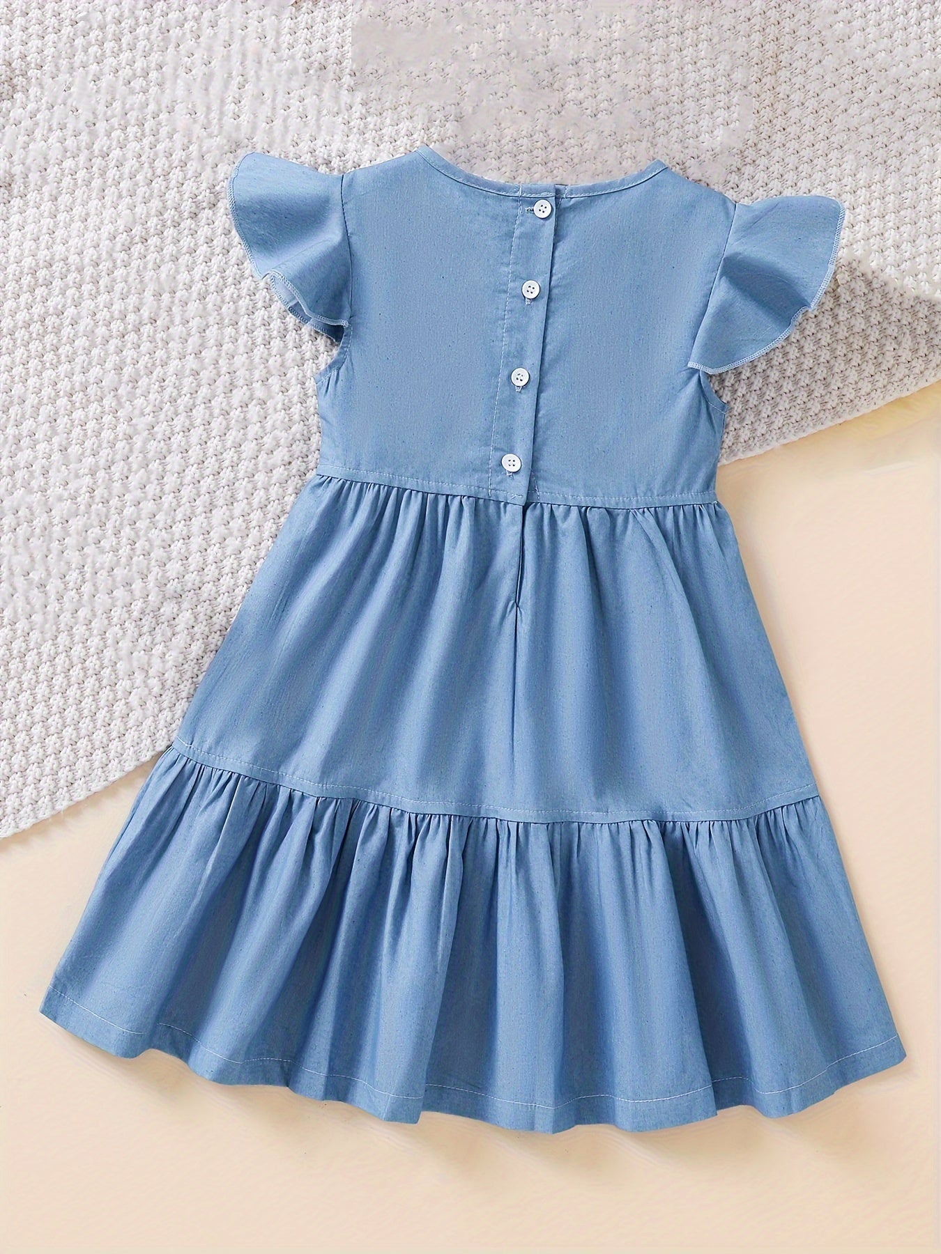 Stylish denim dress for girls with ruffle trim, made of cotton blend and machine washable, ideal for summer