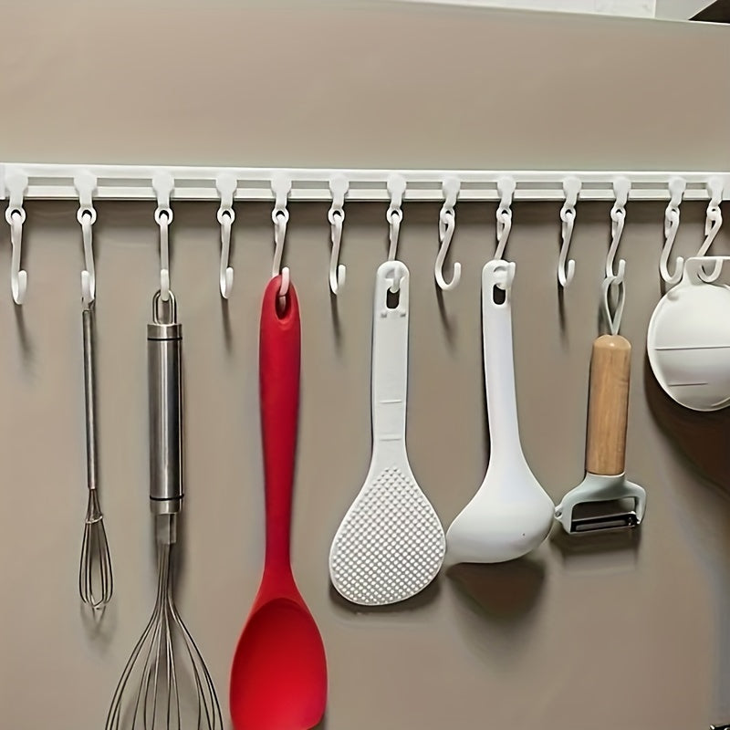 Kitchen storage rack with sliding hooks for easy installation, no drilling necessary; adhesive backing for convenient organization and utility hooks.