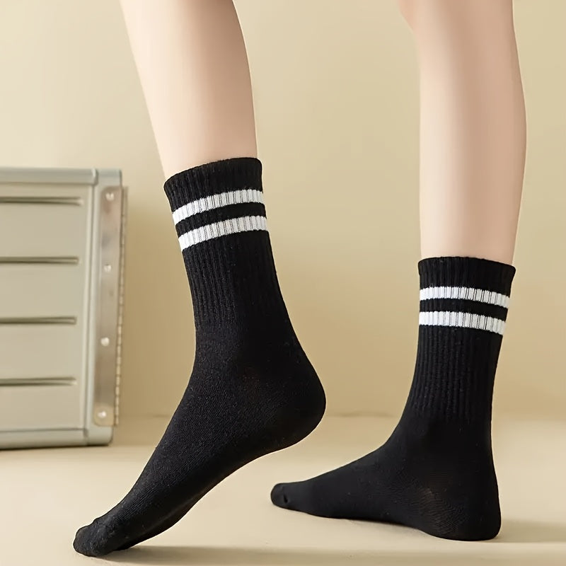 3 pairs of knee-length striped socks for women in black, white, and grey. Made of breathable polyester knit fabric with a casual sport style. Hand wash or dry clean.