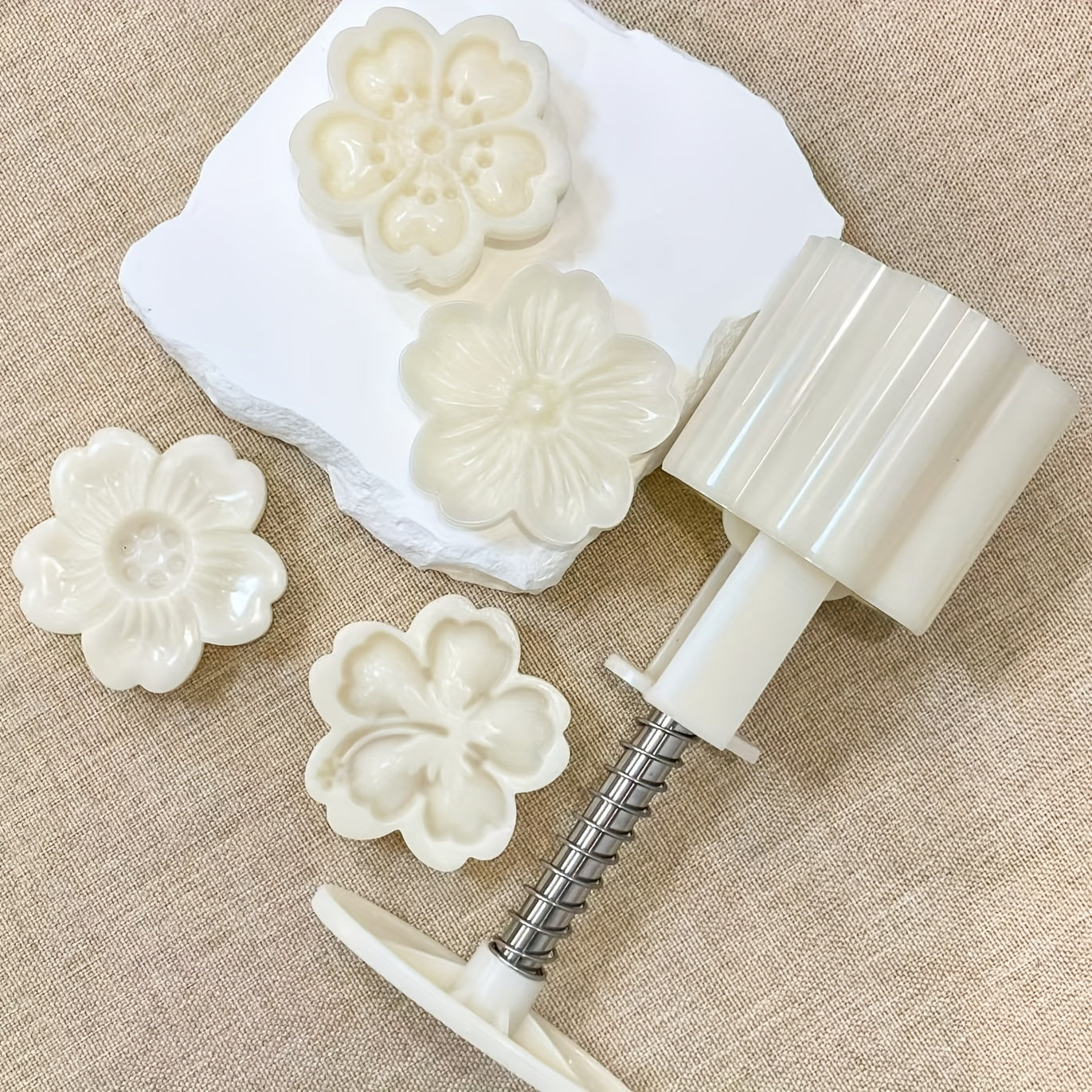 Set of 4 plastic mooncake embossing molds with blossom design for baking and crafting desserts.