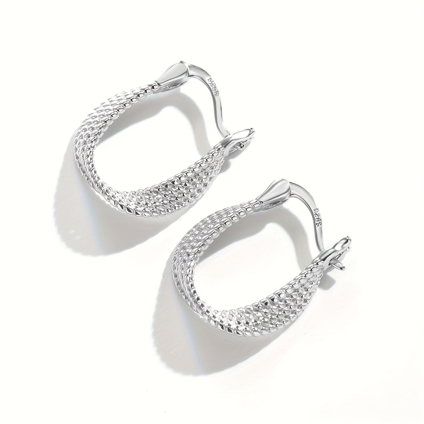 Classic and elegant, these twisted design hoop earrings are made of S925 sterling silver, making them hypoallergenic and perfect for sensitive ears. A timeless and exquisite gift for any woman.