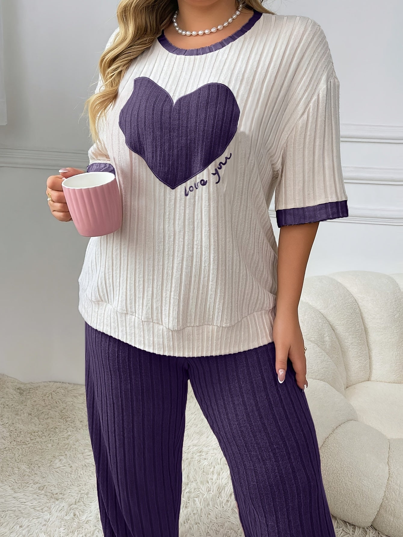 Cozy heart embroidered pajama set in plus size, includes short sleeve top and long pants made of soft polyester. Machine washable.