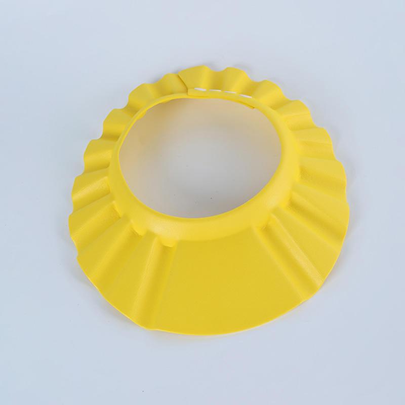 Adjustable baby shampoo cap in pink and yellow, made of soft polyester, protects eyes and ears during hair washing. Ideal for bathing and hair care.