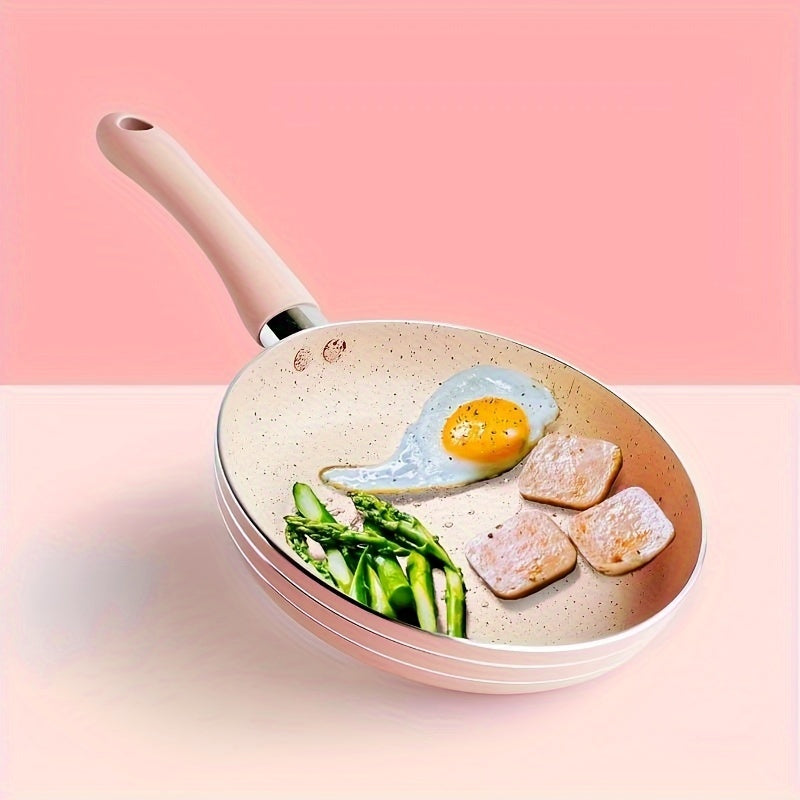 Pink aluminum mini frying pan with a flat bottom and silicone handle, measuring 16.51cm in size. Lightweight and suitable for frying eggs and steaks on a gas stove.