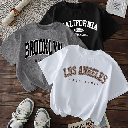 Three casual geometric-patterned t-shirts for women, polyester crew neck short sleeve tees with regular length knit fabric, featuring prints of Brooklyn, Los Angeles, and California.