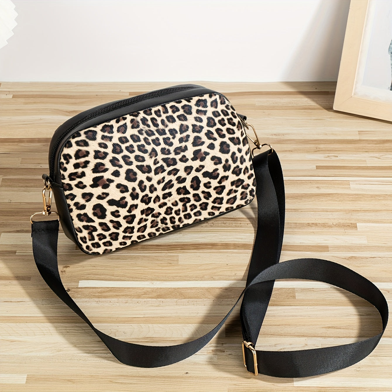 Chic leopard print crossbody bag with adjustable strap, cat charm, zip closure, and polyester lining - ideal for work, outings, and daily commutes.