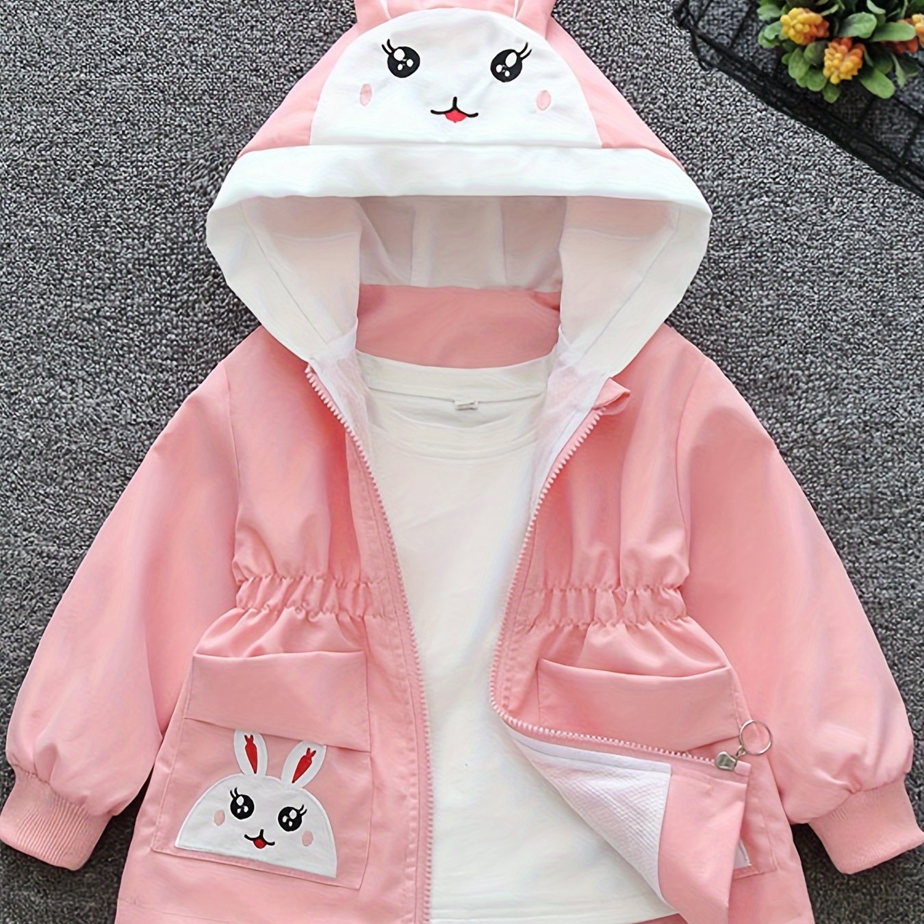 Girls' cute bunny-themed windbreaker in light pink, long sleeve, polyester blend, non-stretch fabric with pockets. Ideal for spring and autumn.