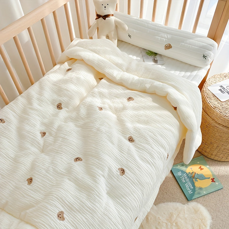 Soft cream-colored quilt with embroidered bear and rabbit, perfect for kids all year round. Made from durable knit fabric for naps and home use.