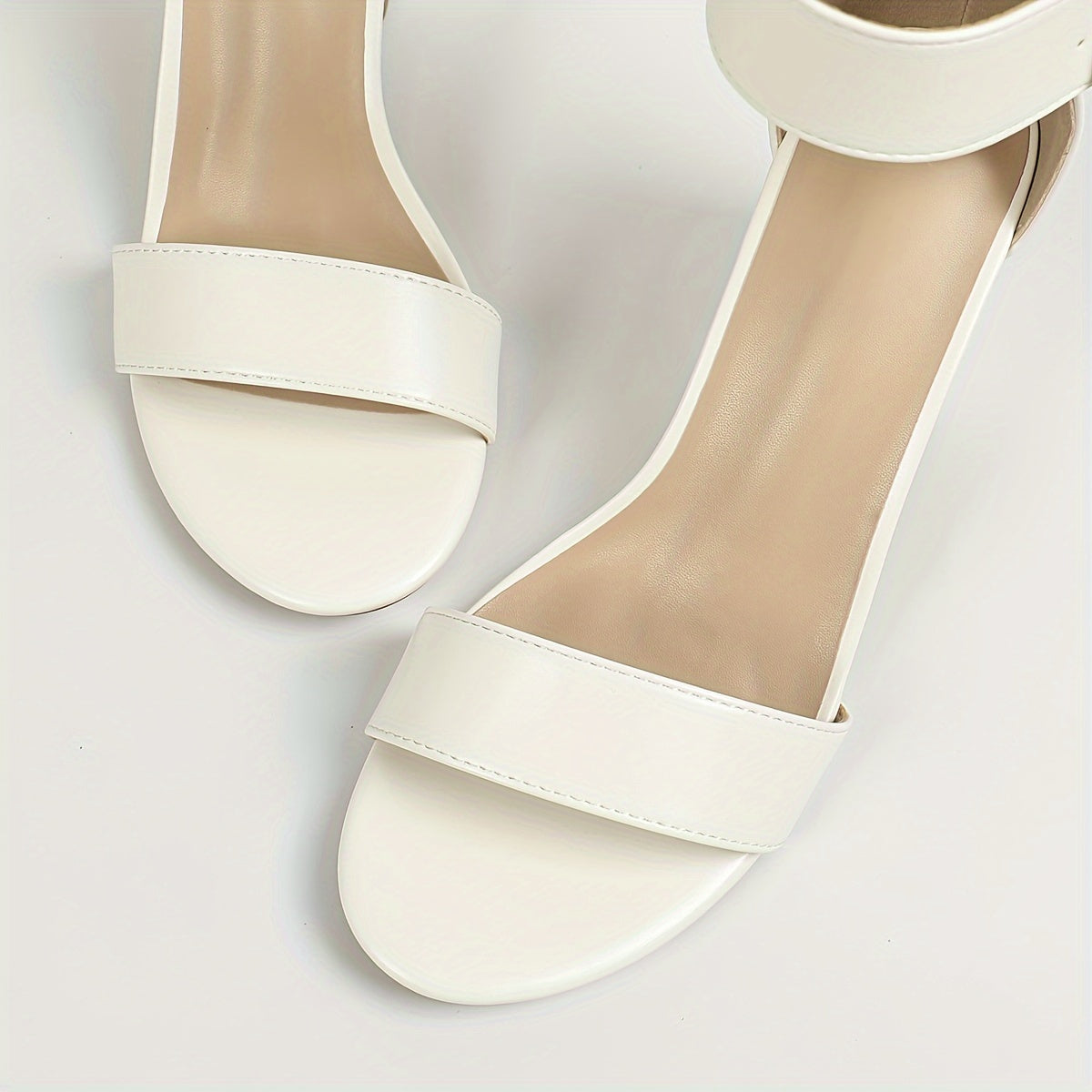 Stylish white block heel sandals with ankle strap and open toe, versatile and comfortable for any occasion.