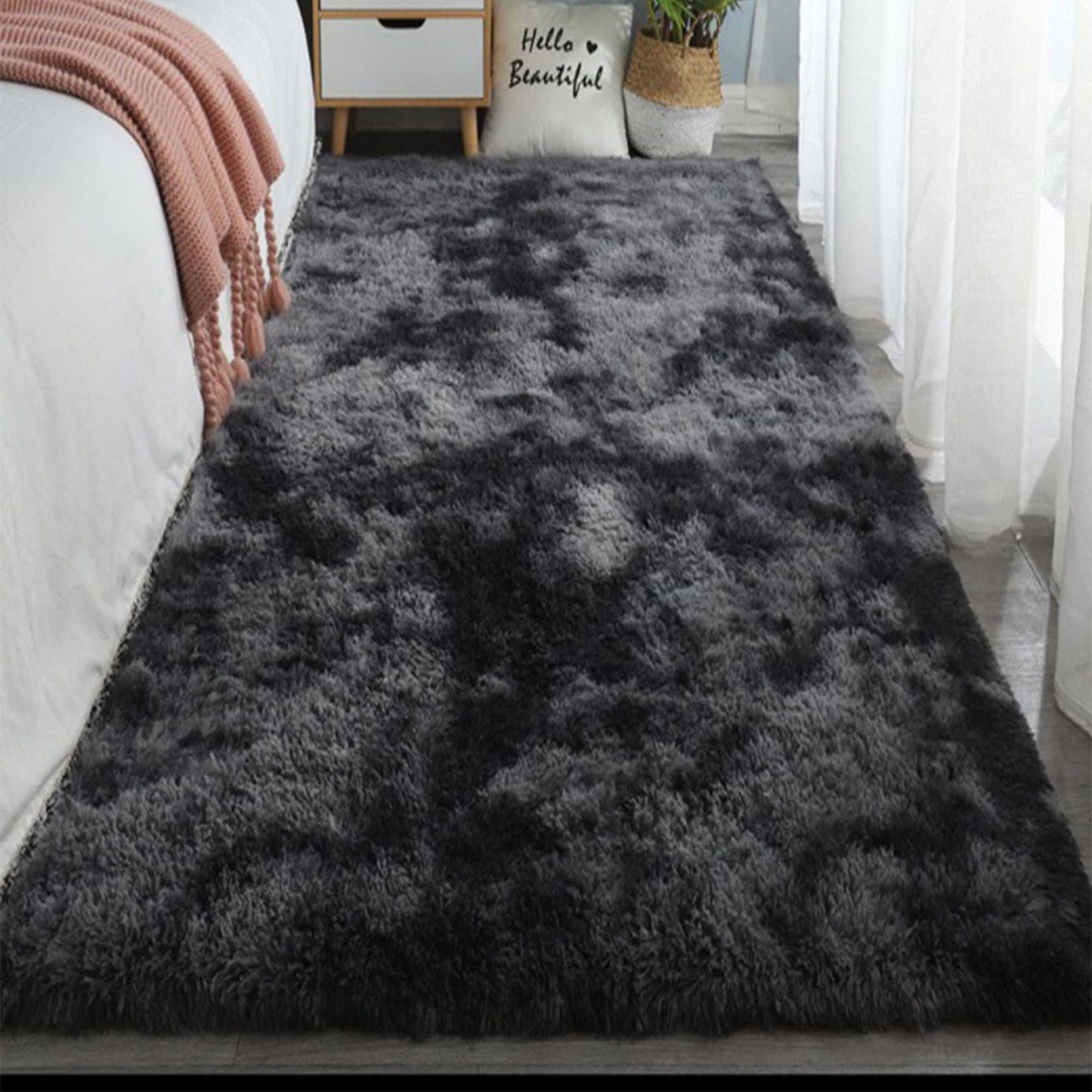 One piece of plush, fluffy area rug designed for bedrooms. This soft, fuzzy shaggy rug is black in color and rectangular in shape, perfect for adding warmth to your living room. It features a non-slip bottom to ensure safety. Great for Halloween or