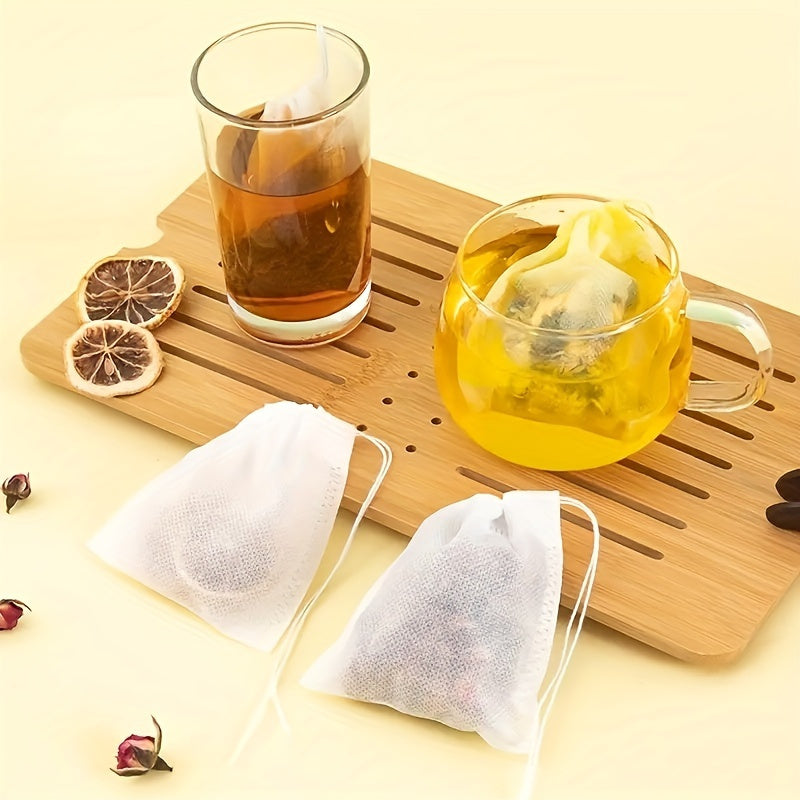 100 pieces of high-quality disposable tea and coffee filter bags with a convenient drawstring closure - ideal for brewing loose leaf tea, aromatic teas, and spices.