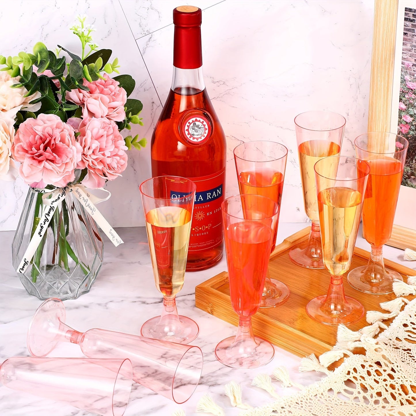 25 pieces of plastic clear disposable champagne flutes, including crystal pink champagne flutes. These cocktail cups and plastic glasses are perfect for weddings, picnics, gatherings, and parties. Get yours now for all your party supply needs!