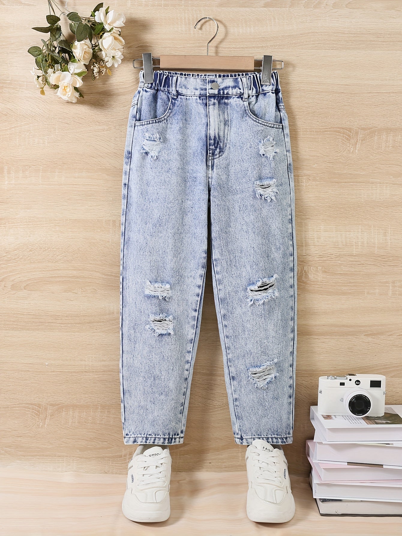 Girl jeans are stylish and versatile for all seasons, with specially designed holes for a trendy look.