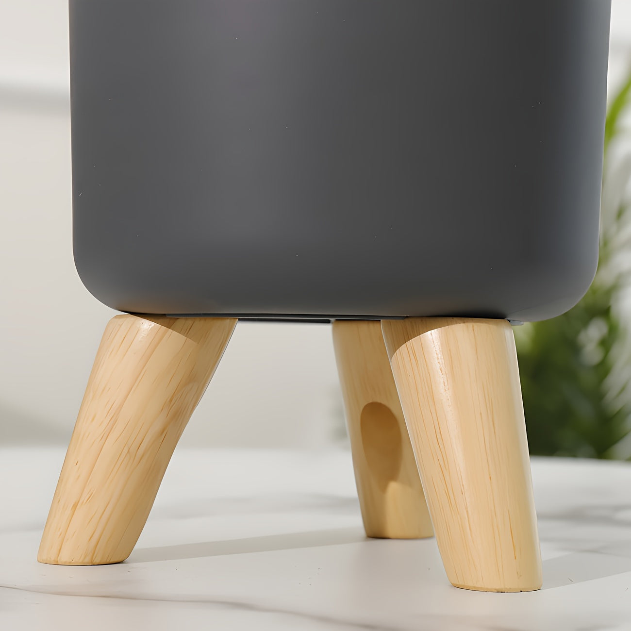 Wooden leg planter for indoor/outdoor use in home or office, suitable for various plants.