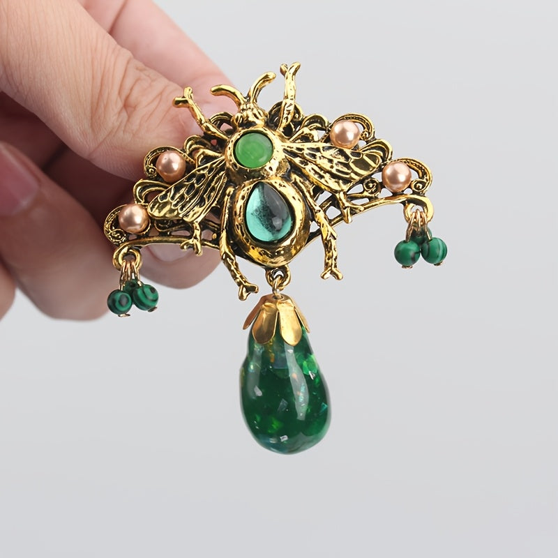 Bee brooch pin with vintage-inspired butterfly design, adorned with rhinestones and intricate green enamel accents, perfect for adding flair to coats and dresses.