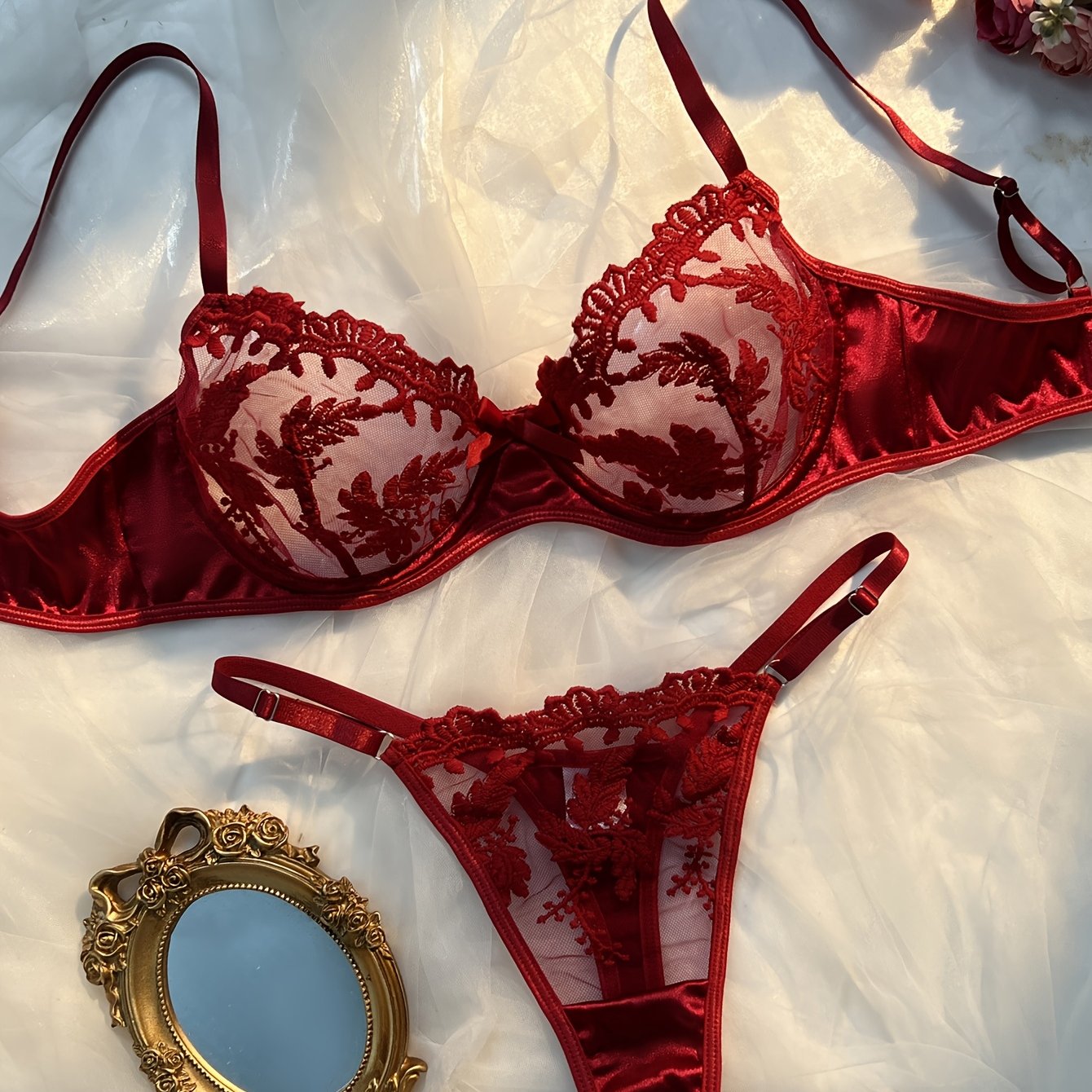 Floral embroidered lingerie set in burgundy, made from 97% polyester and 3% elastane knit fabric. Features medium support, no padding, thong panty, and drop waist - perfect as a Valentine's