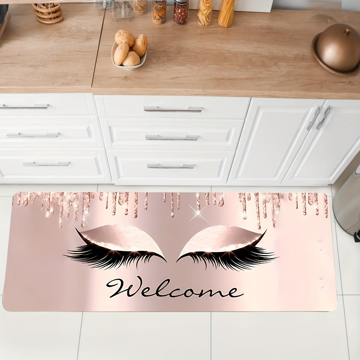 Pink eyelashes and letters patterned kitchen rug made of polyester vinyl material. This mat is anti-slip and absorbent, perfect for use in the kitchen, home office, sink area, or laundry room. It also provides anti-fatigue properties for added comfort.