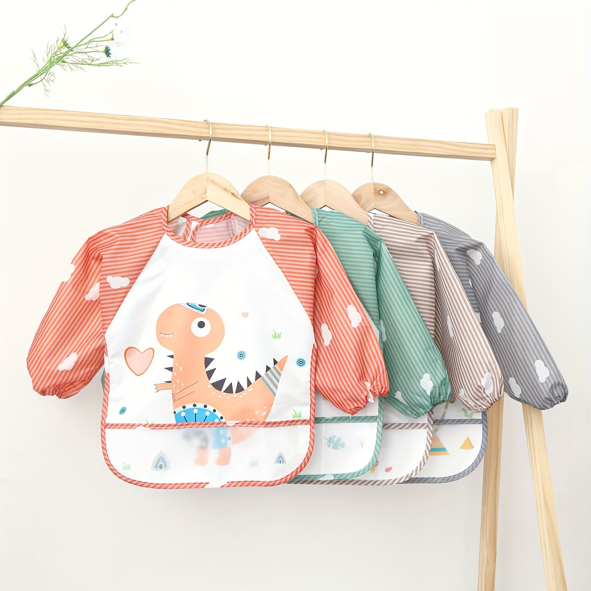 Easily cleanable reverse wear cartoon bib with waterproof long sleeves, suitable for home and travel.