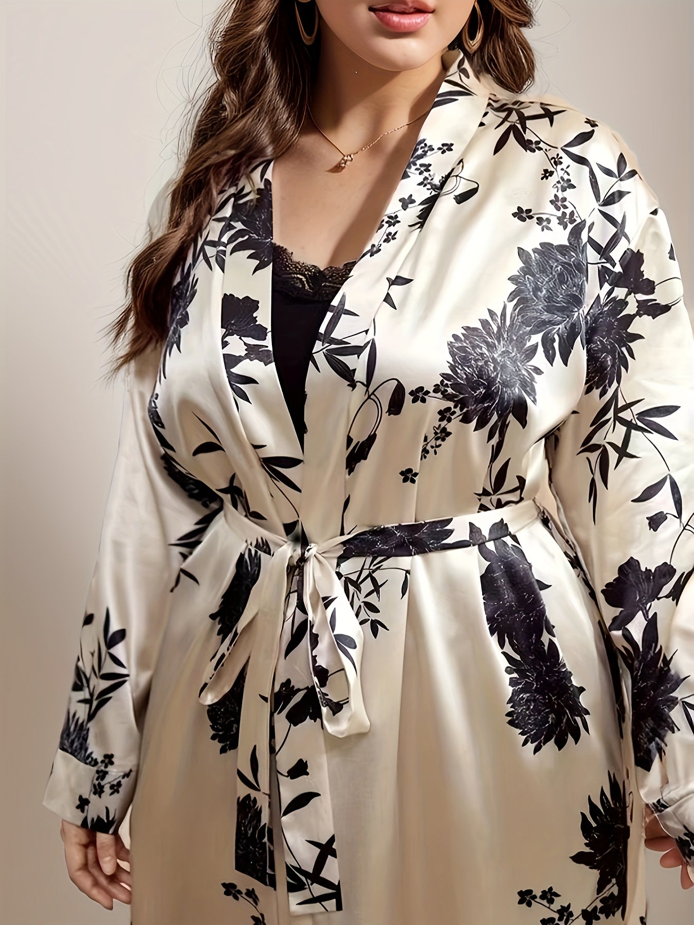 Women's plus size satin robe with floral print, long sleeves, belt, and soft polyester fabric. Perfect for holiday gatherings.