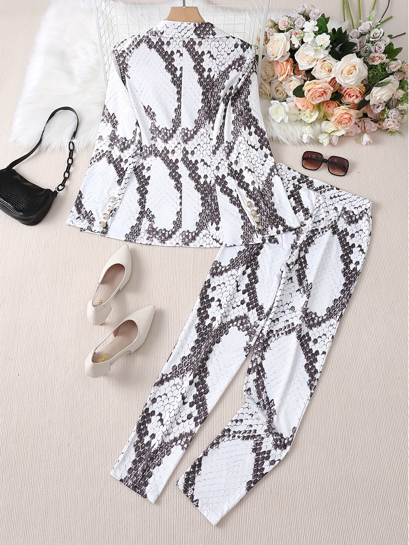 Snakeskin print two-piece set with blazer and pants for women.