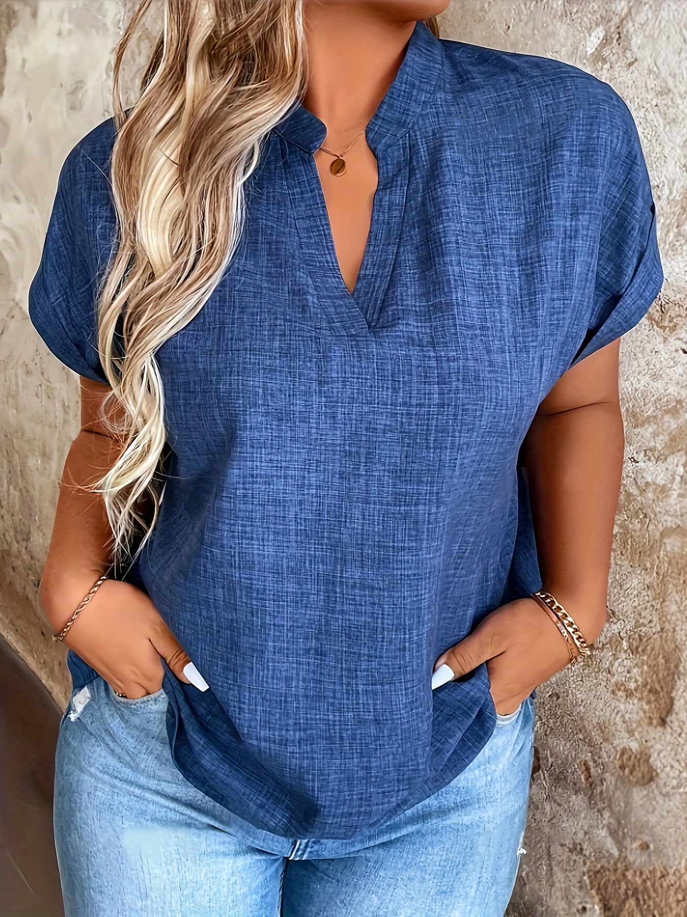 Elegant blue V-neck blouse with batwing sleeves, perfect for spring/summer. Made of machine washable polyester fabric, ideal for casual summer wear.