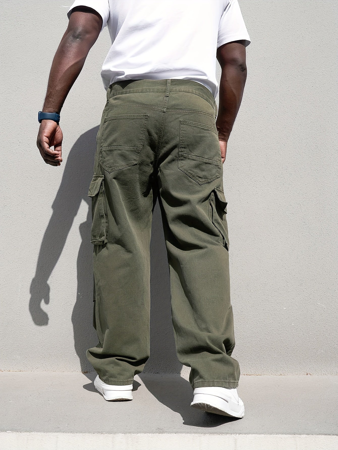 Men's plus size casual denim trousers with loose fit, cotton cargo pants featuring multiple pockets for a trendy look.