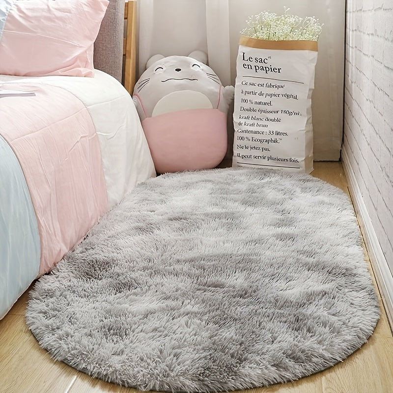 Soft and fluffy oval area rug, designed for use in living rooms, bedrooms, game rooms, and dormitories. Made of non-slip, washable polyester material. Machine-made shaggy rug perfect for adding a cozy touch to your space. Ideal for use as a bedside