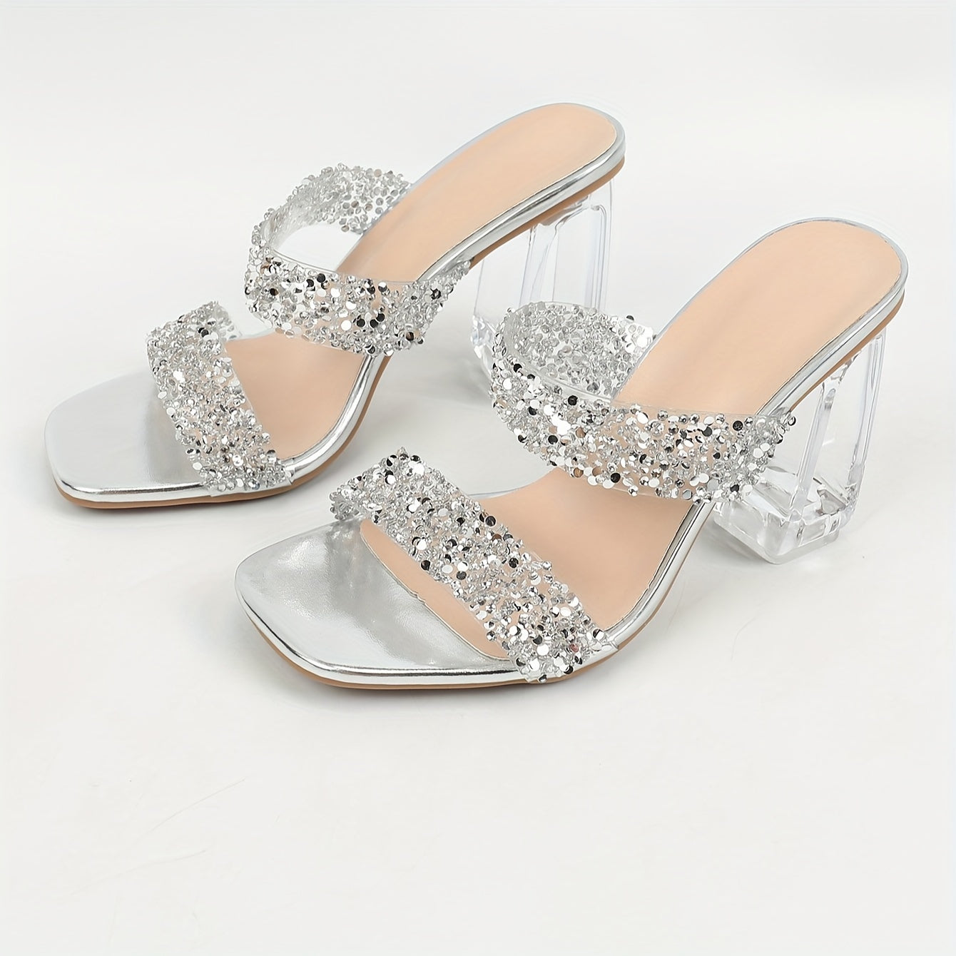 Silvery open-toe mules with crystal heels and clear chunky heels for women add charm with shiny decorations, ideal for summer parties indoors and outdoors.