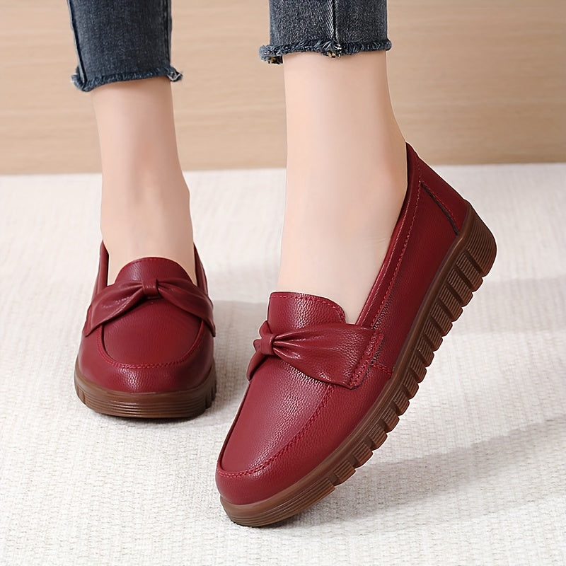 Women's comfortable penny loafers with bow embellishment, non-slip sole, round toe, all-season footwear, man-made materials, TPR sole.