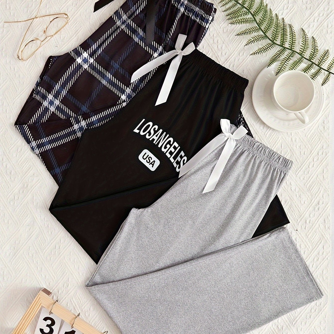 3 Women's lounge pants with plaid and "LOS ANGELES" print. Made of comfy polyester blend with elastic waist and bow detail. Suitable for all-season sleepwear and casual wear.