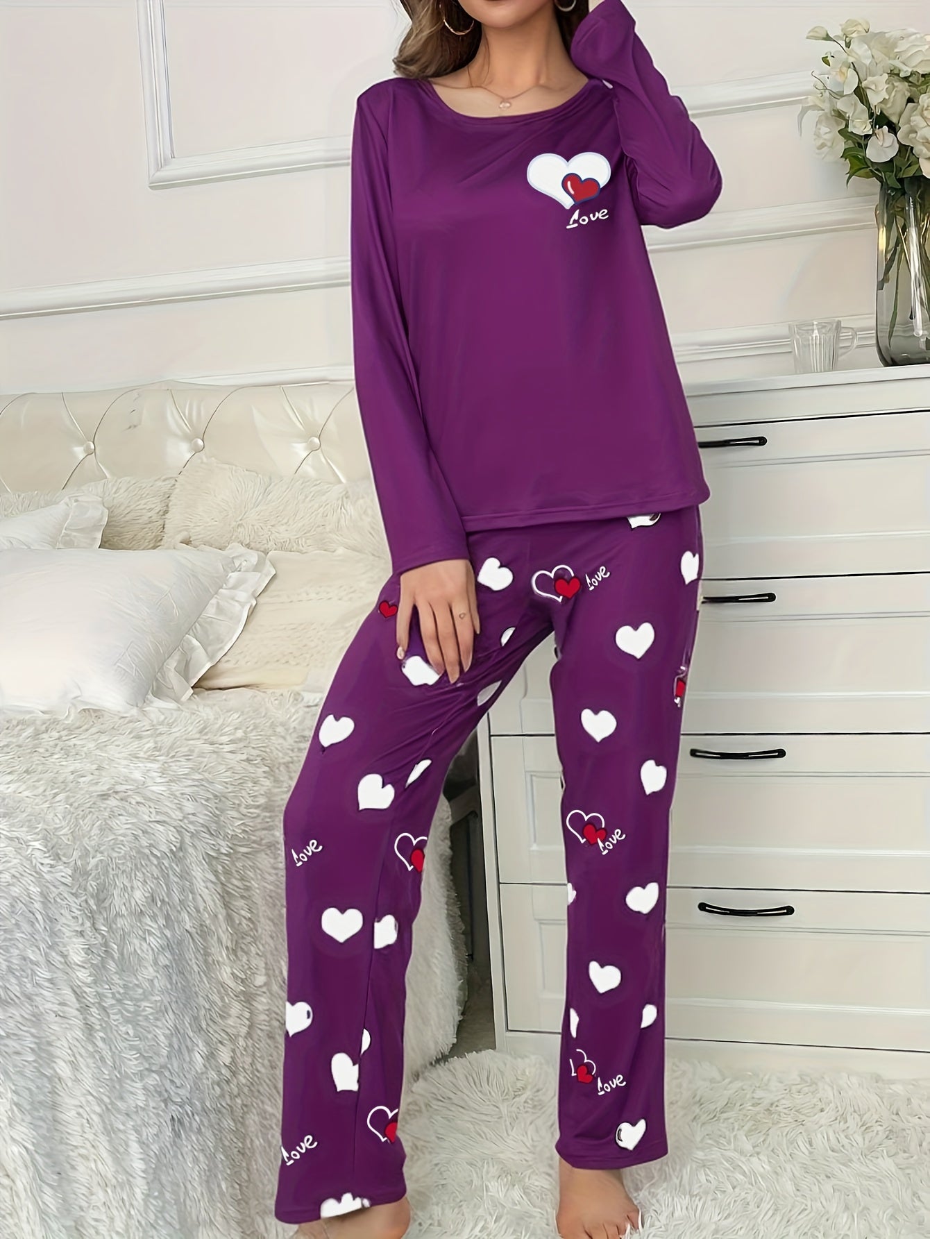 Women's heart print 2-piece pajama set includes long sleeve crew neck top and elastic waist pants in cozy polyester blend for fall/winter.