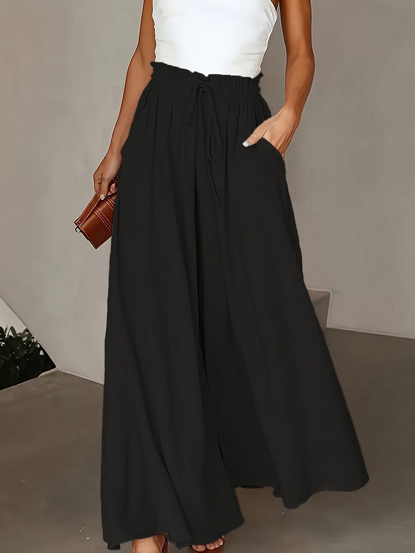 Wide leg flowy pants in a solid color, perfect for spring and summer. Casual high waist design, versatile for women's clothing.