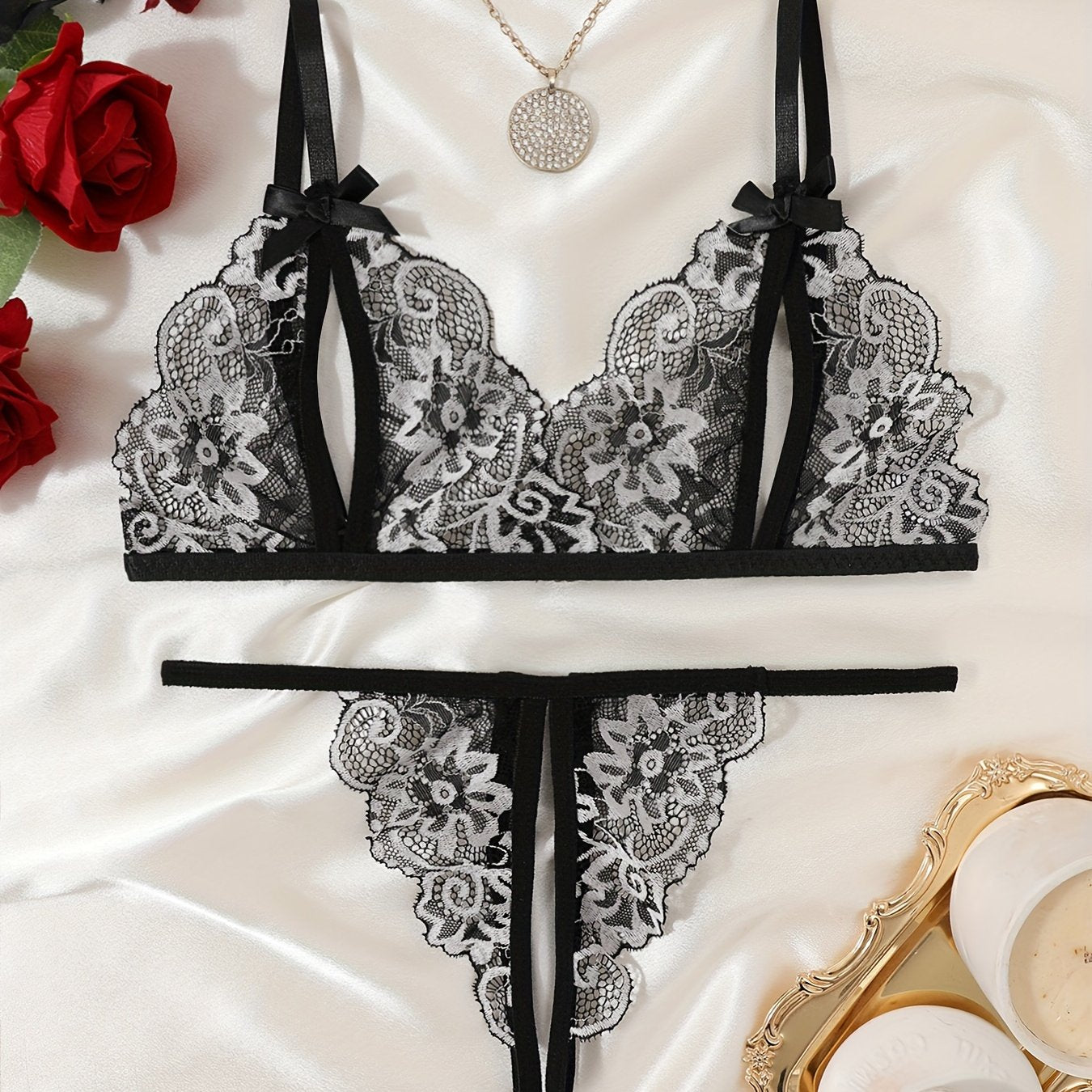 Floral lace lingerie set with cupless bralette, bow detail, crotchless thong panty, and intimate boudoir wear.