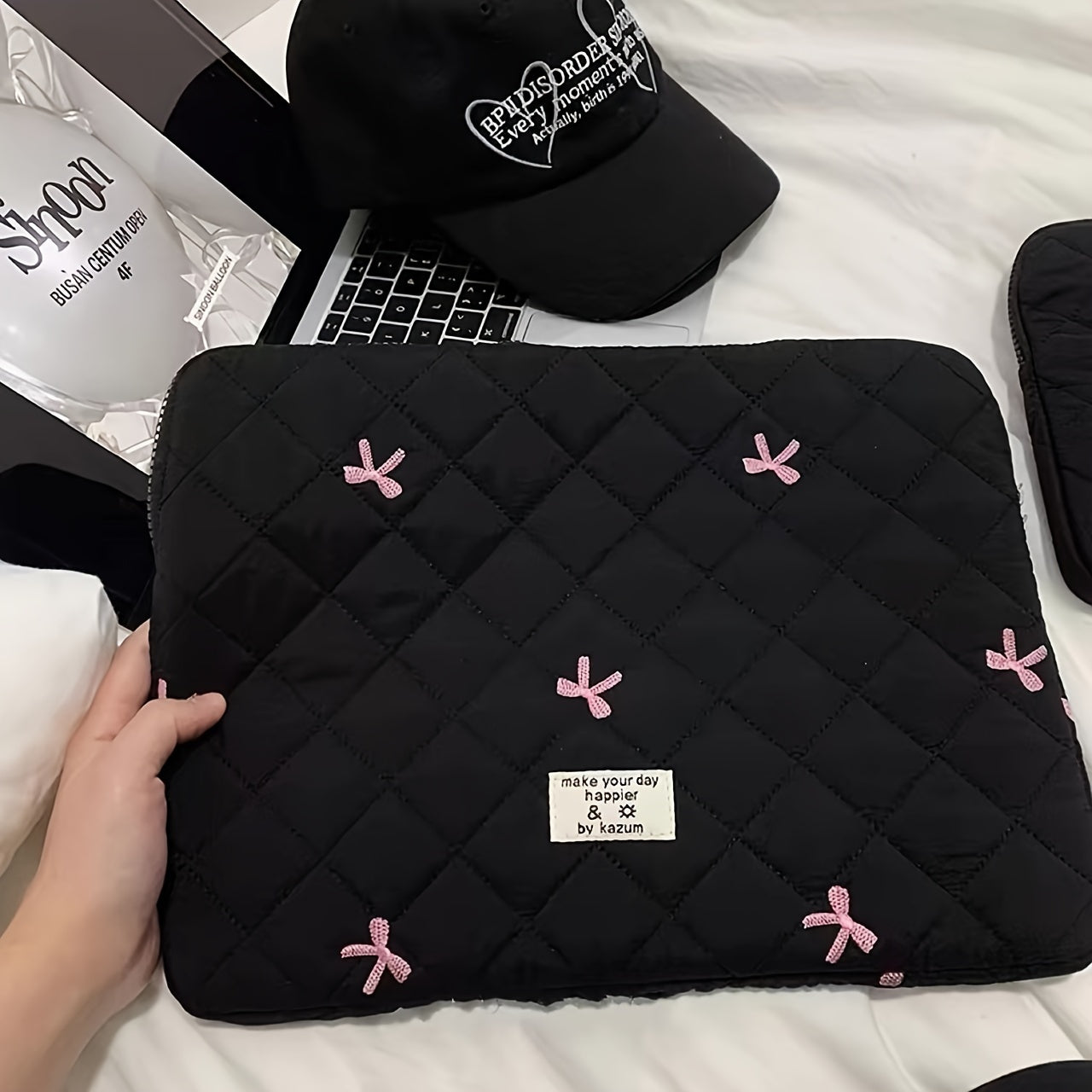 One laptop bag with ballet style bow embroidery, suitable for various devices.