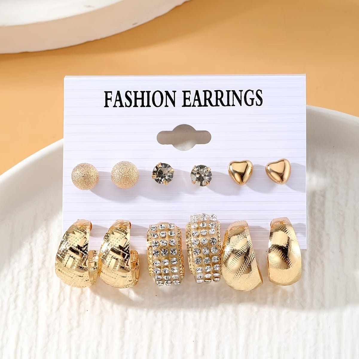 Punk style 6-pair set of metal earrings with textured and heart studs. Made of zinc alloy with rhinestones and stainless steel posts. Versatile for daily and party wear. Perfect gift