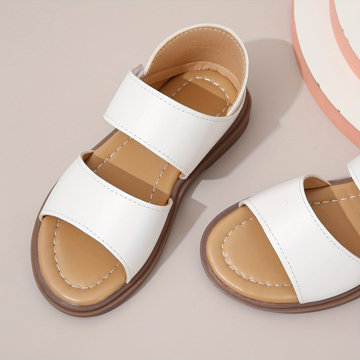 Stylish summer sandals for girls: open-toe design with braided straps and flat sole, ideal for casual wear and festivals.