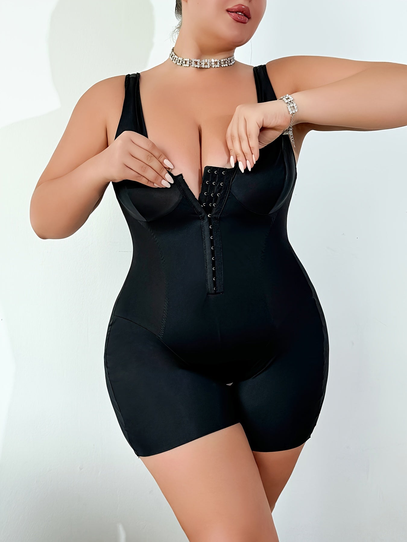 Sleeveless plus size bodysuit with front closure and open crotch.