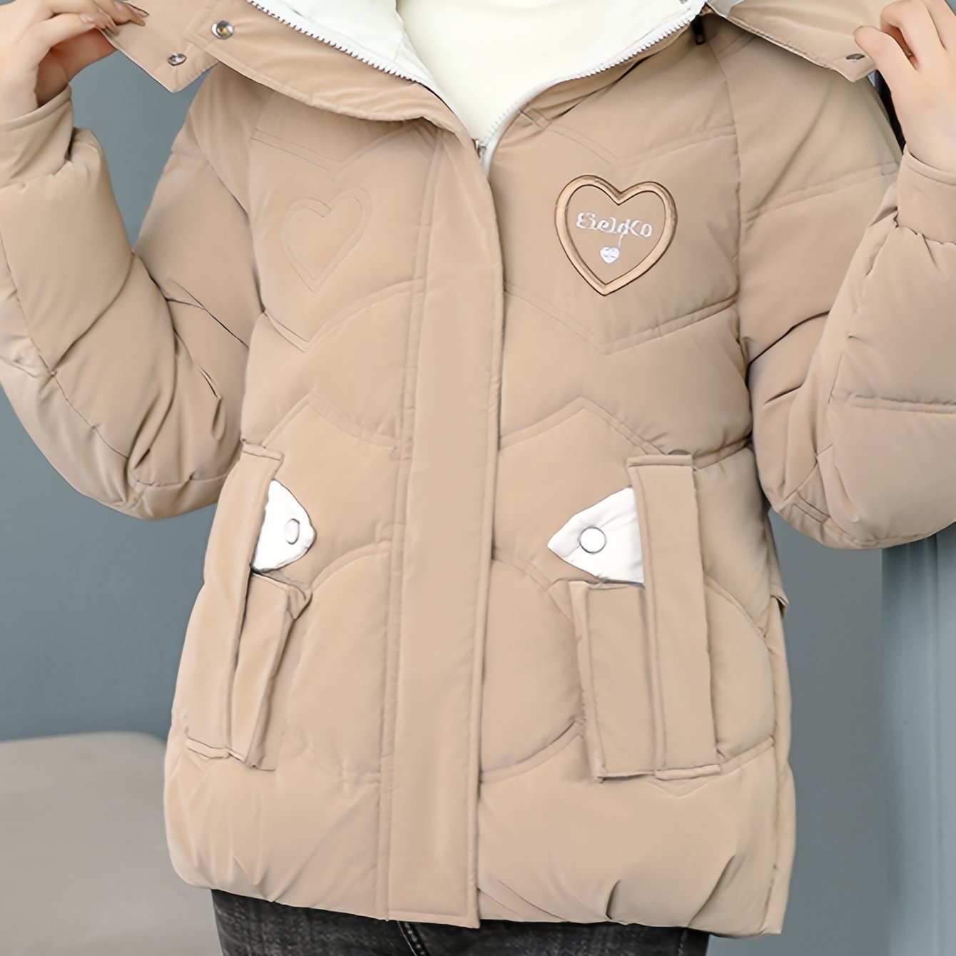 Stylish black winter jacket for women - Thick polyester with fashionable hood and heart logo detail, perfect for casual moms and ladies. Zipper closure.