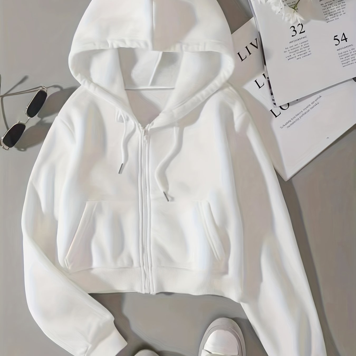 Drawstring zip-up crop hoodie with thermal lining and long sleeves, featuring a front pocket.