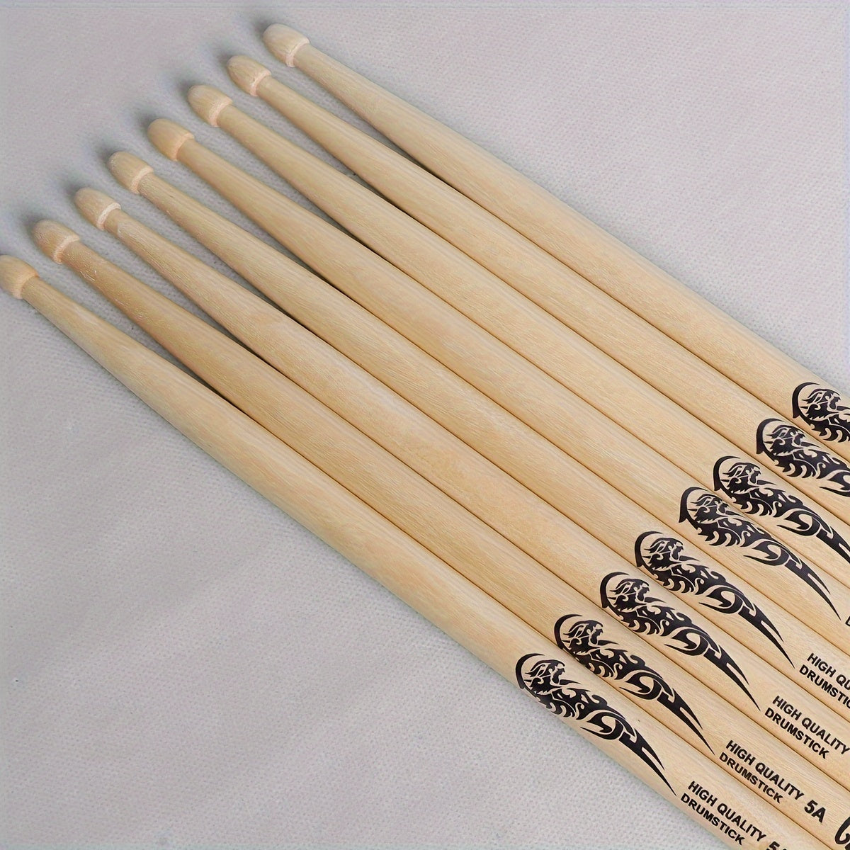 Lightweight drumsticks with totem design, selectable sizes 5A, 7A, and 5B. Made of high-quality natural wood with a precision grip, uncharged pair.