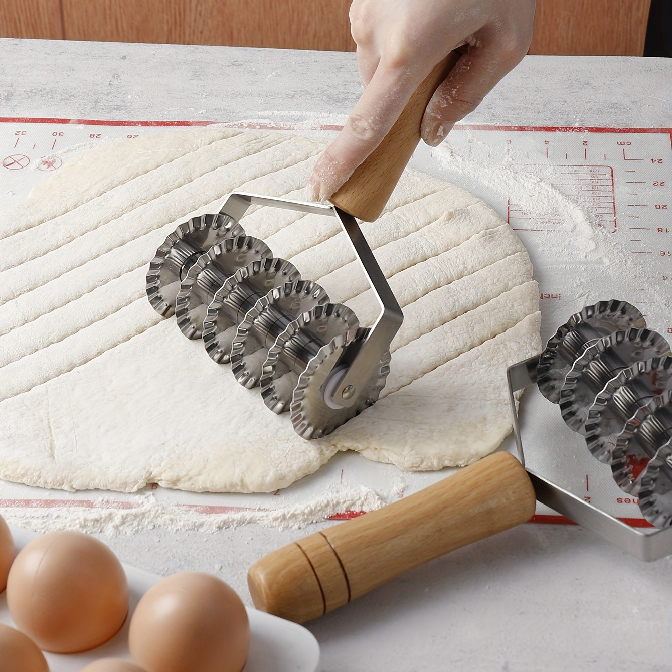 Six-wheel stainless steel cookie and noodle cutter with a wavy wood handle - Perfect for cutting cookies and noodles in the kitchen.