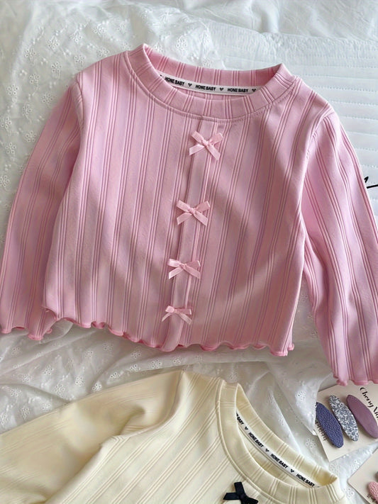 Stylish long-sleeve t-shirt with bow detail for girls, perfect for leisure and outdoor play, also makes a great gift.